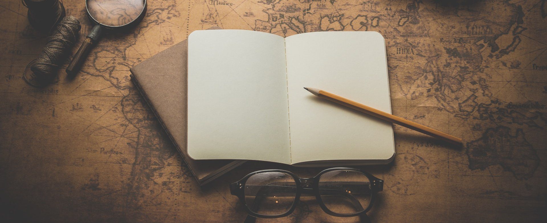 Blank Journal, Reading Glasses, And Magnifying Glass